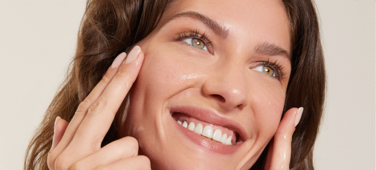 Close-up of a woman applying moisturizer – glow guide skincare tips for radiant and healthy skin